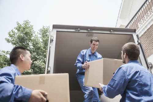 Professional moving team handling boxes and household items
